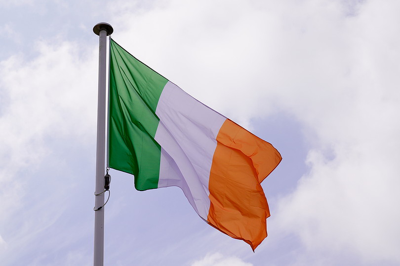 Ireland Flag Against Bright Cloudy Sky